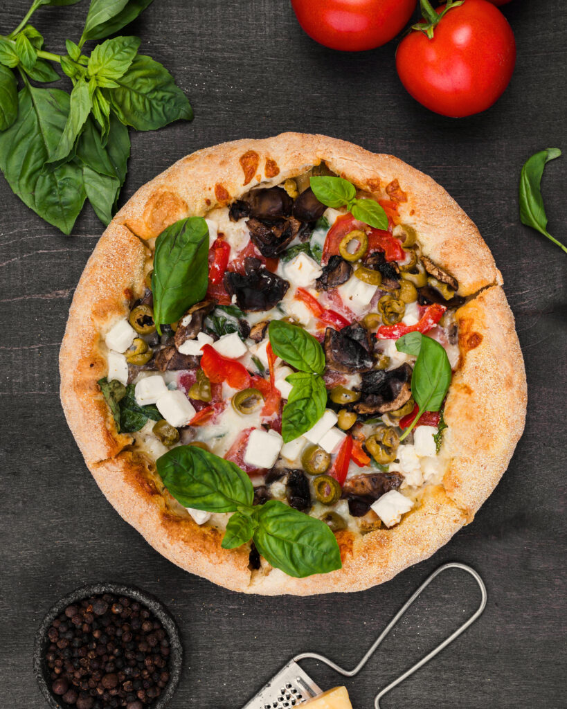 Freshly baked vegan pizza with olives,basil,and plant based cheese -vegan pizza delhi